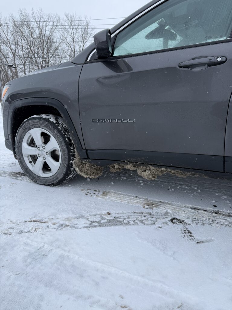SUV with salt caked to its undercarriage.