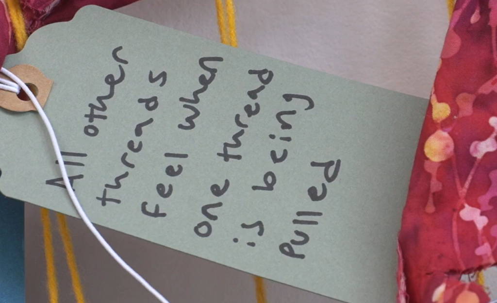 Green tag that reads "All other threads feel when one thread is being pulled."