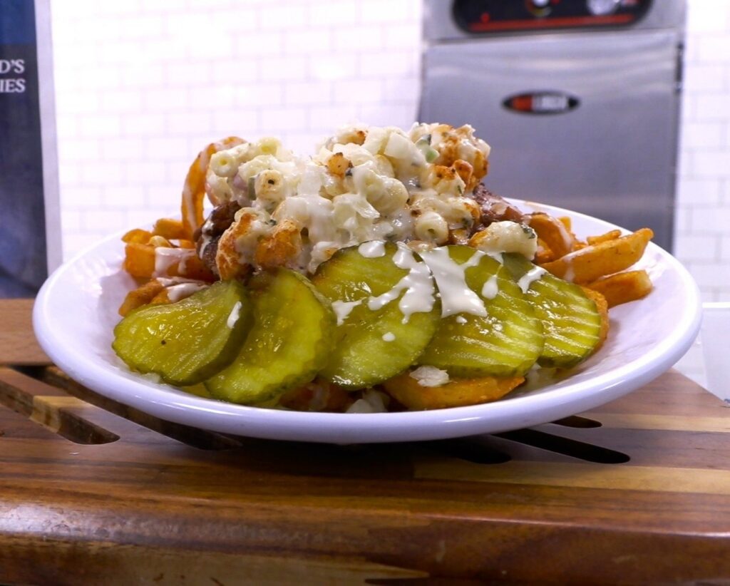 Rochester Garbage Plate: A hearty mix of meats, sides, and sauces.
