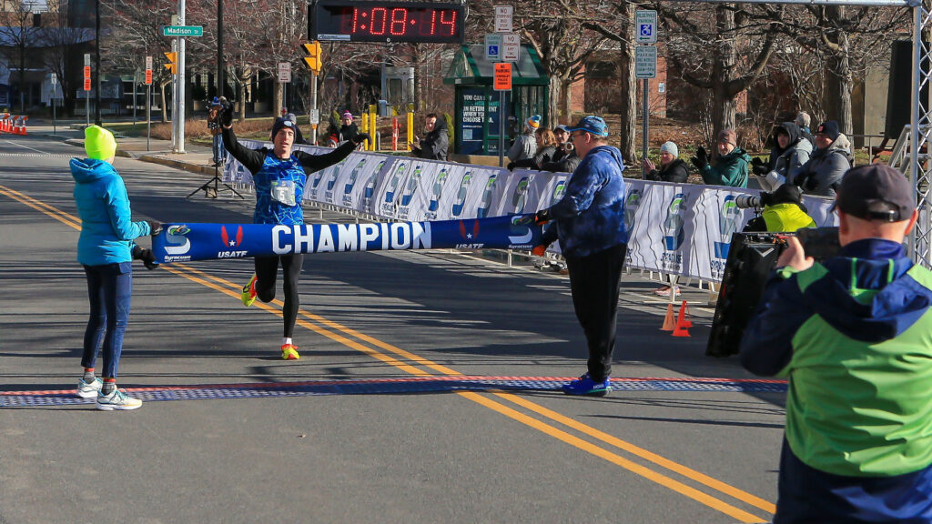 Man crossing road race finish line