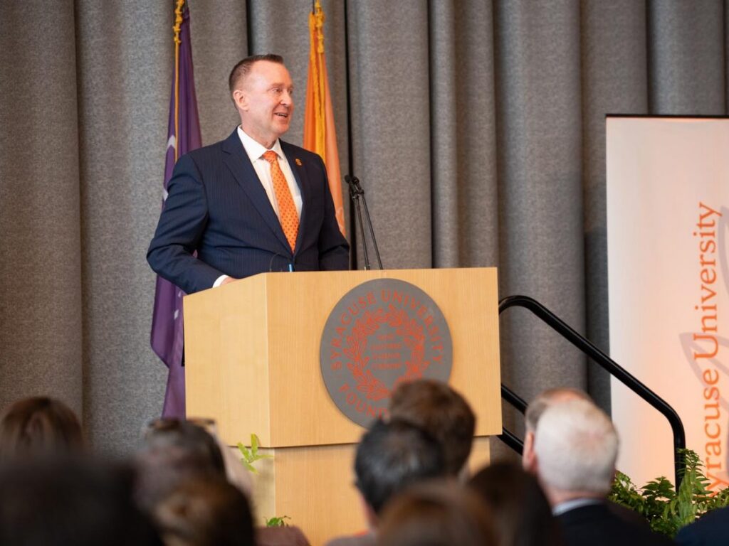 Mike Haynie standing at podium during his announcement as chancellor.
