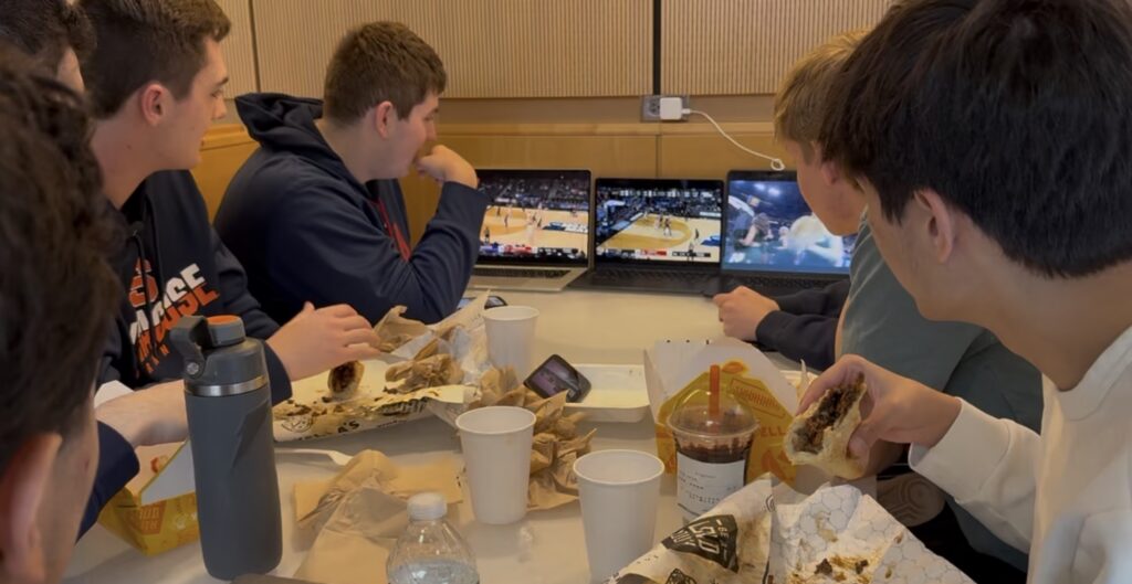 Several Syracuse students watching games with lunch. © Joey Cicini. 2026
