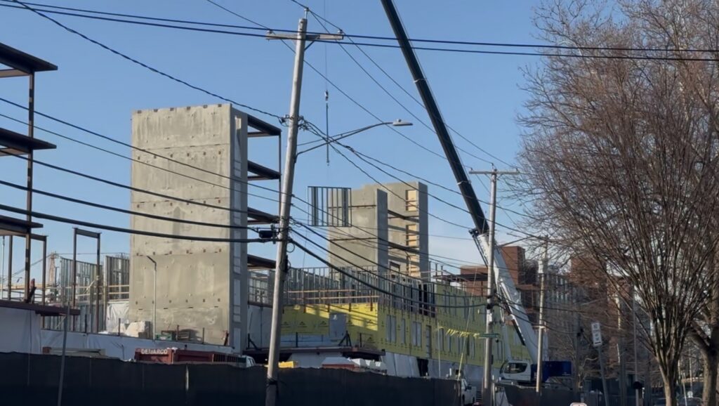 The new dorm project on Ostrom is being erected as the two base concrete pillars are erected.