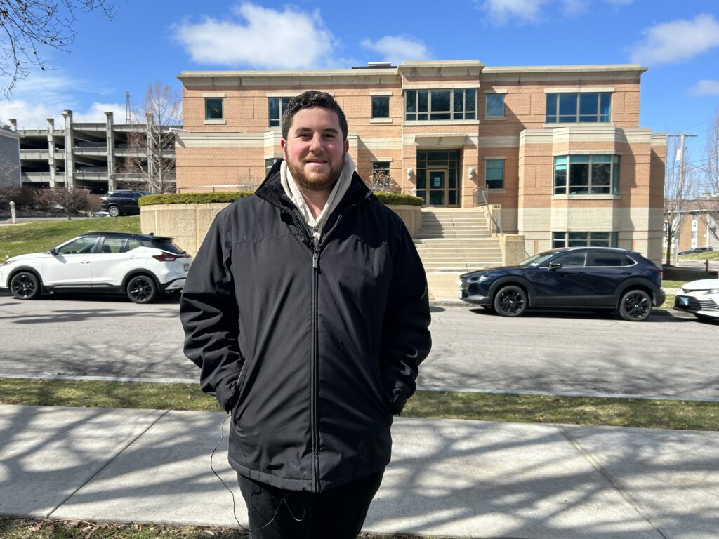 SU student stands in front of the campus Hillel.
