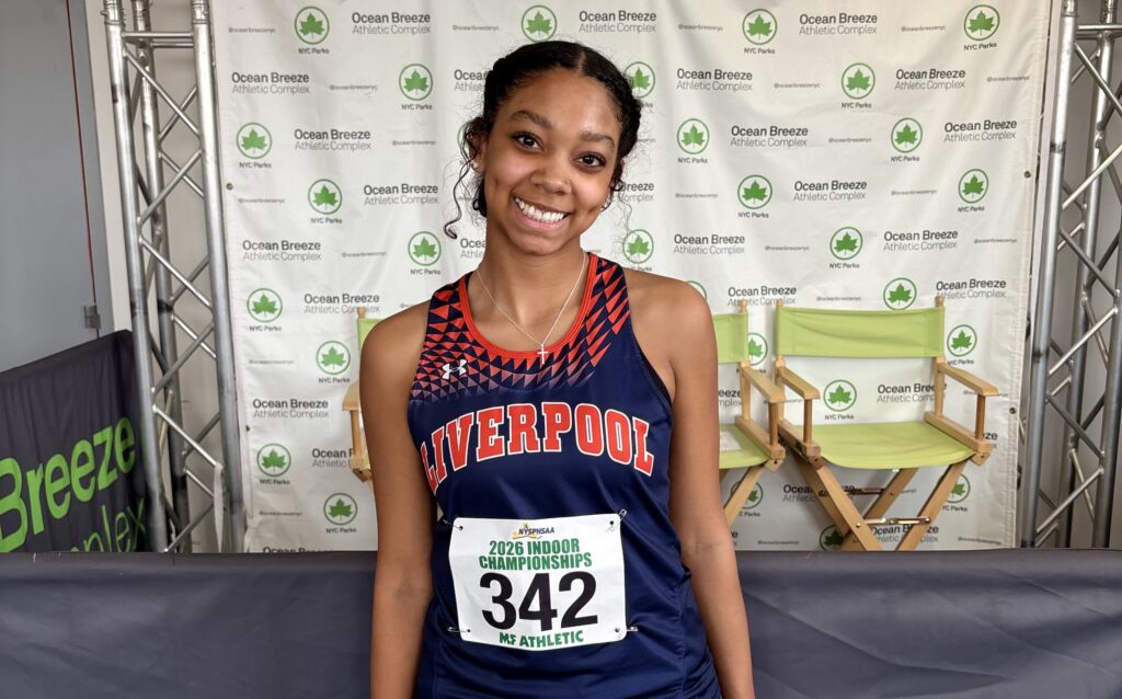 Liverpool high jumper Taima Tearney smiles while wearing her race bib at the New York State Indoor Track and Field Championships