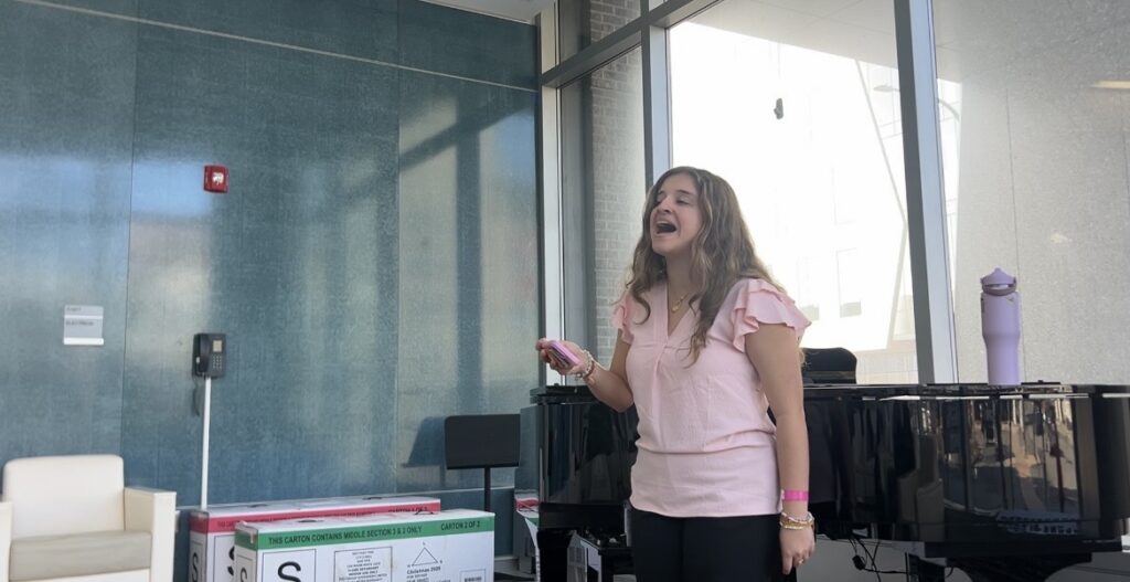 Upstate student sings during a Music as Healing rehearsal in the Upstate Cancer Center lobby. 
