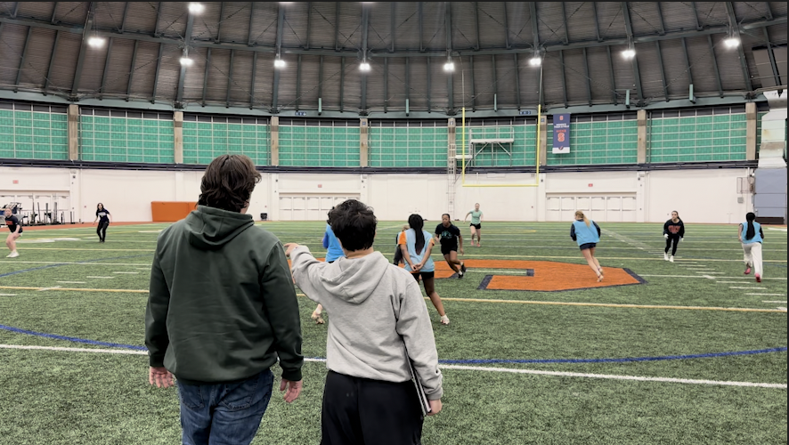Coaches break down the play happening in practice