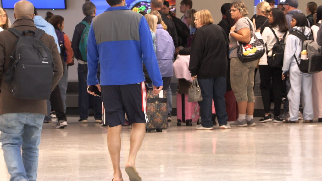 Travelers walking through the airport.