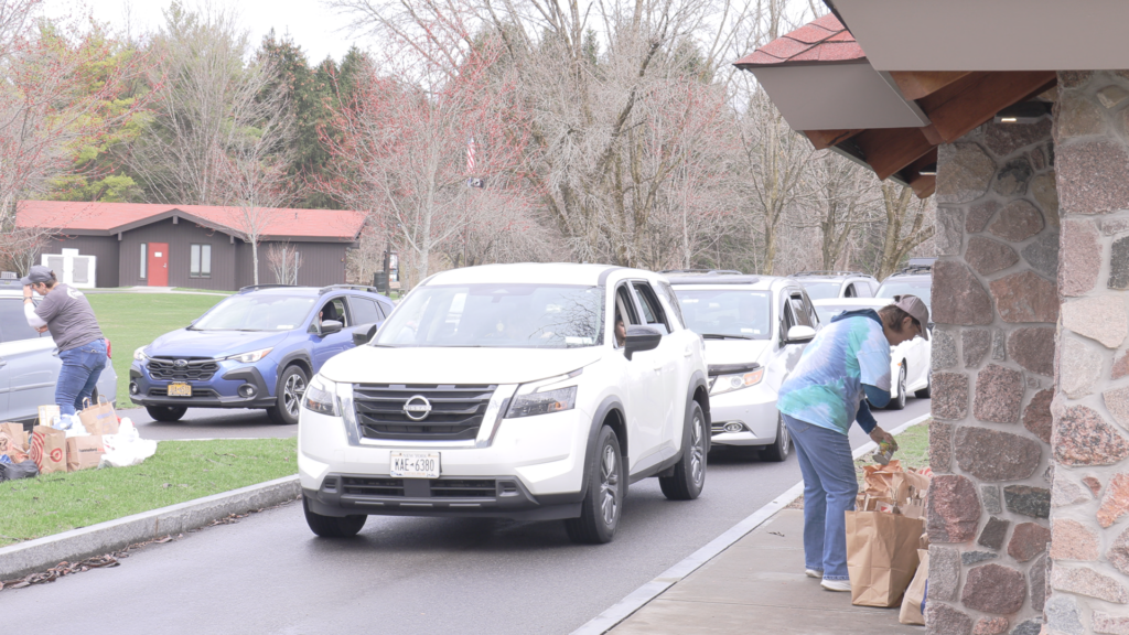 trucks lined up and food bank workers collecting donations