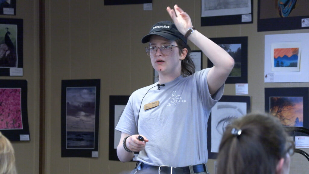 Nora Penhollow instructs a classroom full of naturalists on how to use iNaturalist