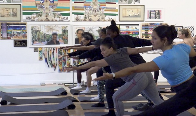 Women in Syracuse practice yoga led by Lisa Newcomb. © Maggie Robinson, 2026