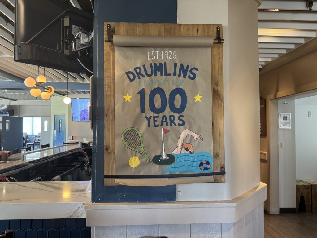 Picture poster that promotes Drumlins Country Club reaching 100 years of existence