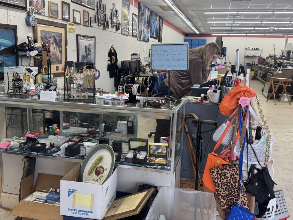 Jewelry and accesories at the front desk of a thrift store.