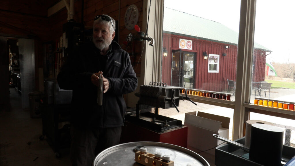 Matthew Critz explains the maple syrup production process to visitors