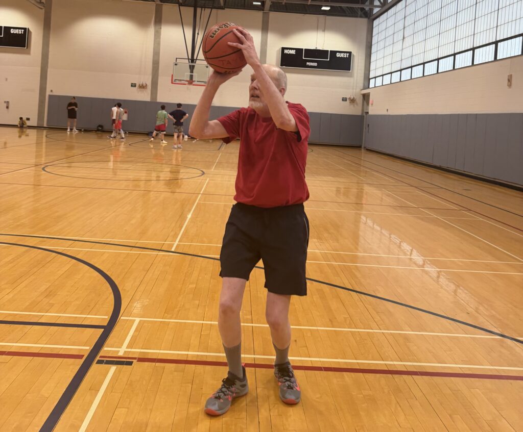 Man shoots basketball