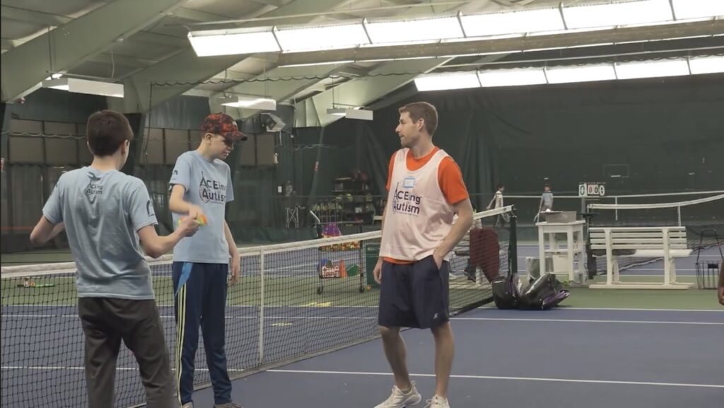 Two players and a volunteer on the court talking up shop.