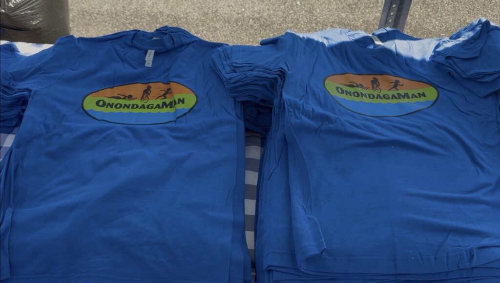 Blue OnondagaMan shirts handed out to particpants