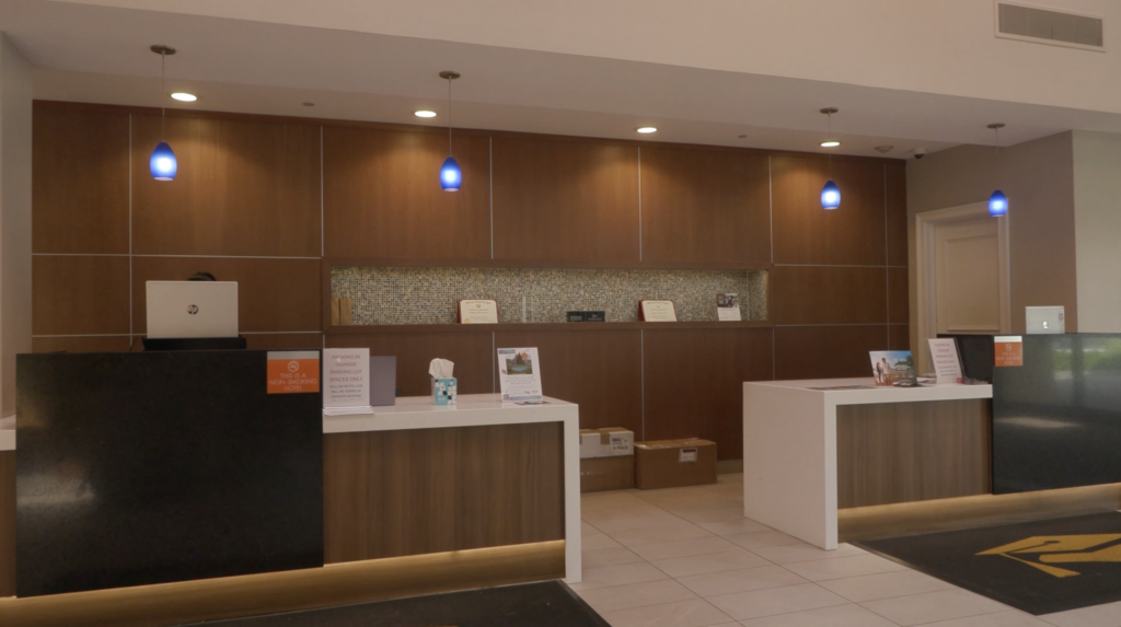 The check-in desk at the Collegian Hotel & Suites near the Syracuse University campus