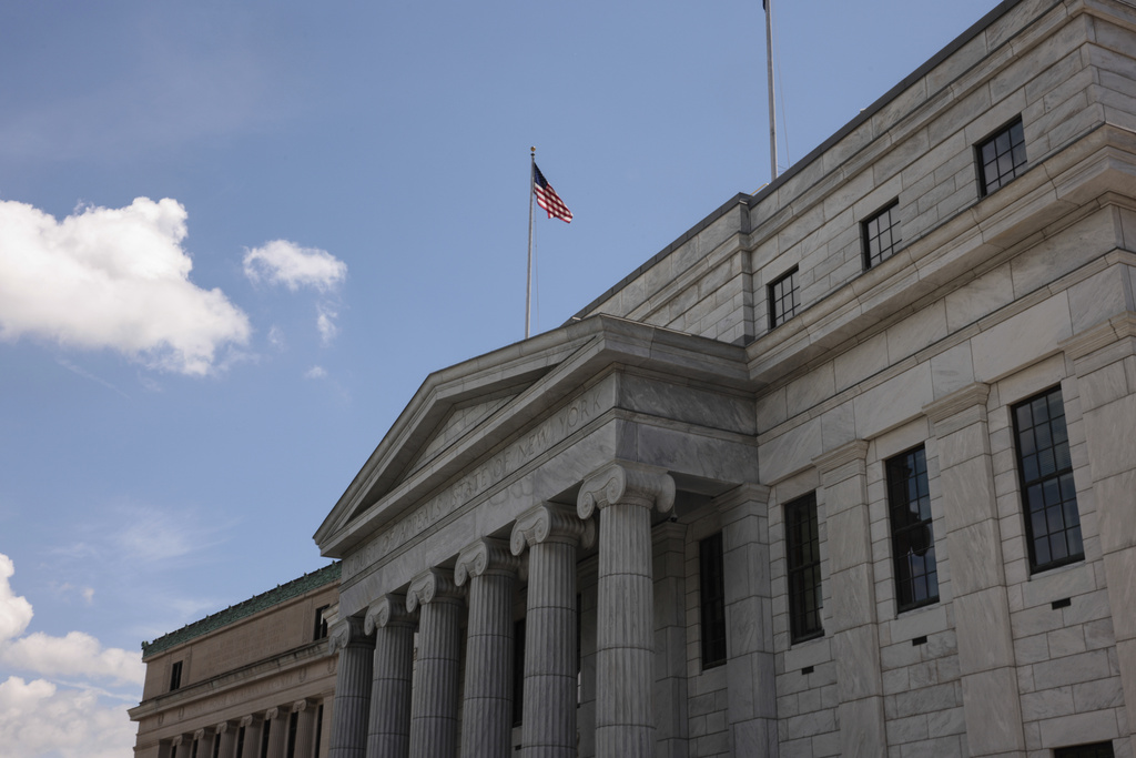 The outside of the NYS Legislature builiding, with an American flag on top.
