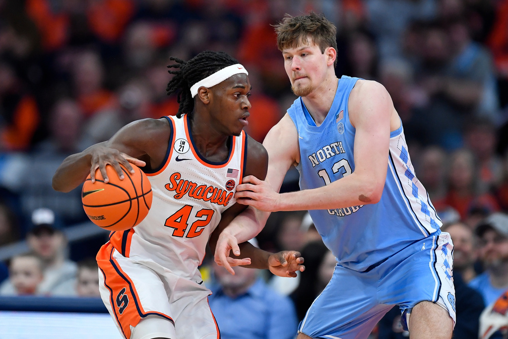 Syracuse forward William Kyle III (42) is defended by North Carolina center Henri Veesaar (13) during the first half of an NCAA college basketball game Saturday, Feb. 21, 2026, in Syracuse, N.Y. Copyright 2026 Associated Press/Adrian Cross
