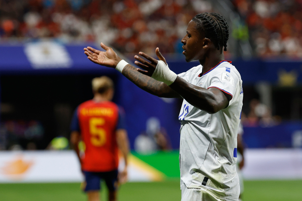 Cabo Vere player raises is hands in reaction during. 