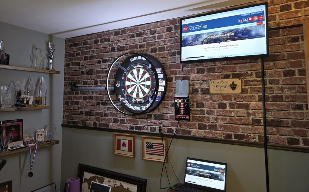 Cali West's dart board and computer used for competing online.