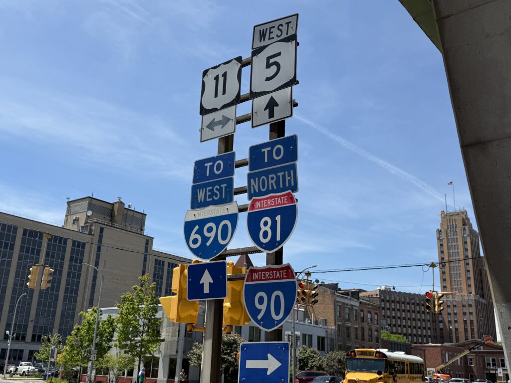 Traffic moves beneath the I-81 and I-690 interchange at Erie Boulevard and South State Street in Syracuse, an area that residents and activists say has long been impacted by vehicle emissions and poor air quality. 