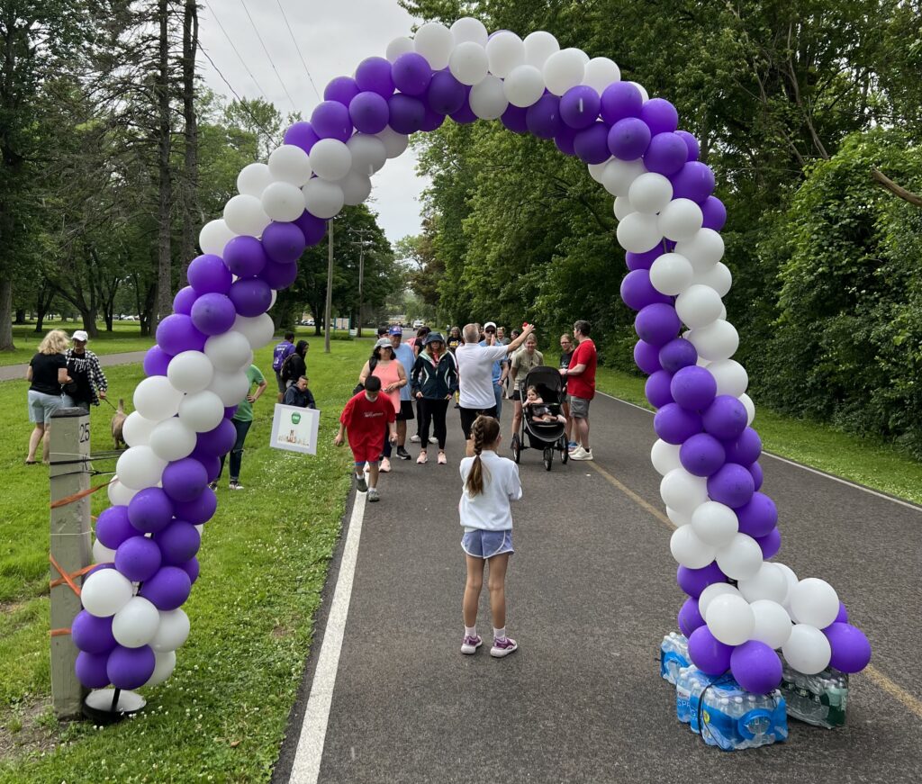 Members and supporters of Devin's Rec Room gather before the start of the third annual Never Walk Alone 5k.