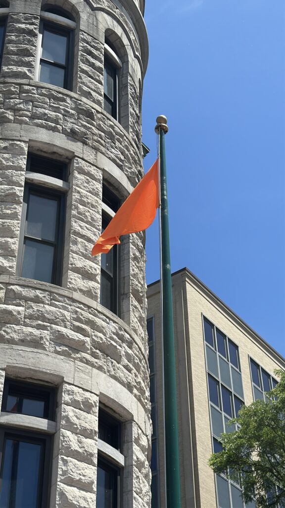 The orange gun violence awareness flag is raised outside of Syraucse City Hall