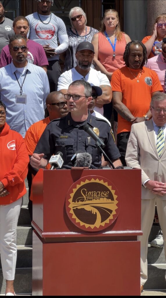 Police Chief Mark Rusin addresses city of Syracuse during the flag raising ceremony.