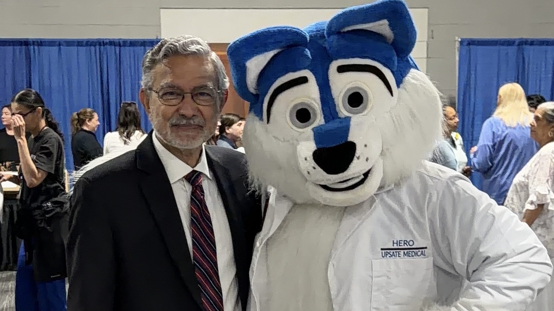 President Dr. Mantosh Dewan with the mascot "Hero the Wolf" at Upstate's 42nd Annual Employee Appreciation Day at the Oncenter in downtown Syracuse.