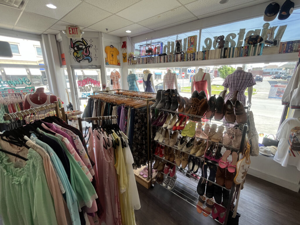 Plenty of clothing options are available inside the store, including a shoe rack.