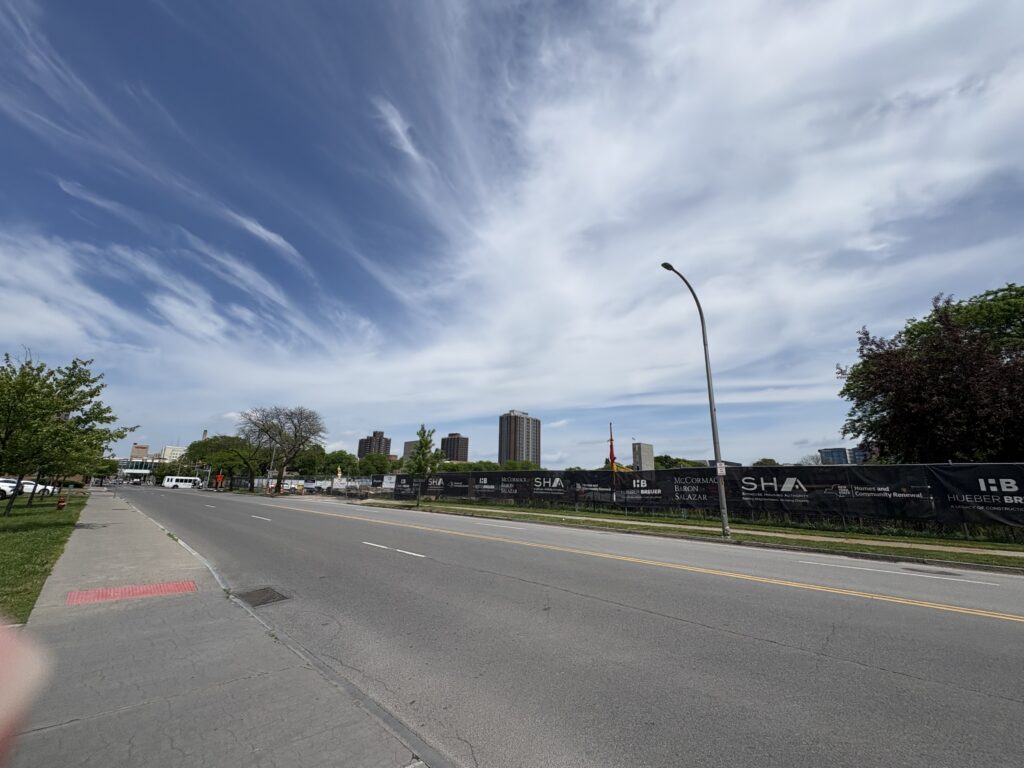 A view of a road next to construction for additional housing units in downtown Syracuse