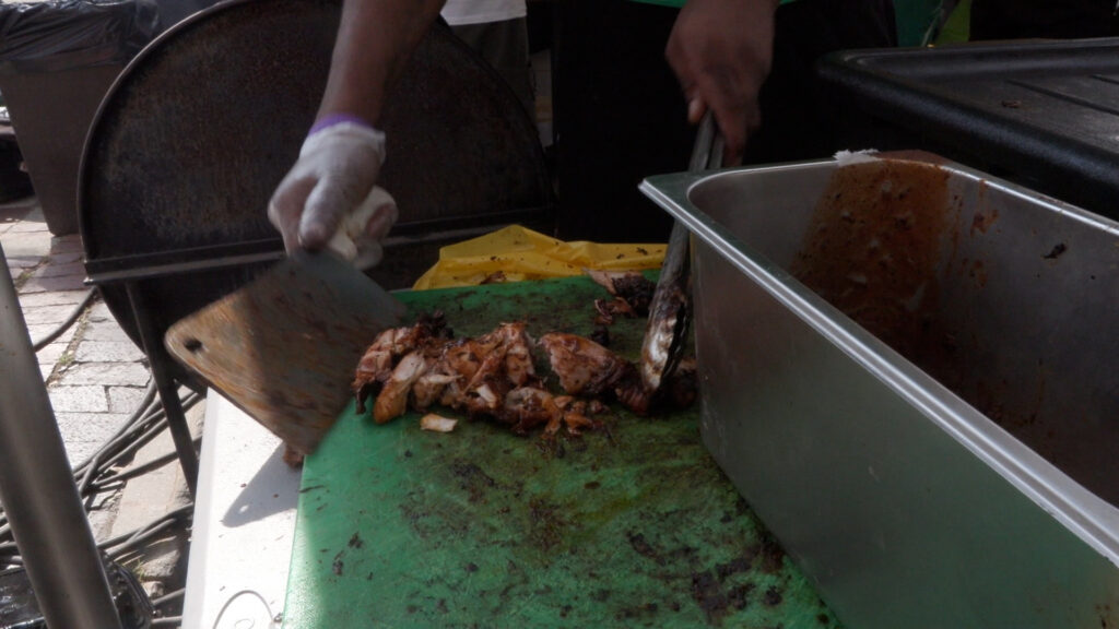 Jerk Chicken being put by a knife