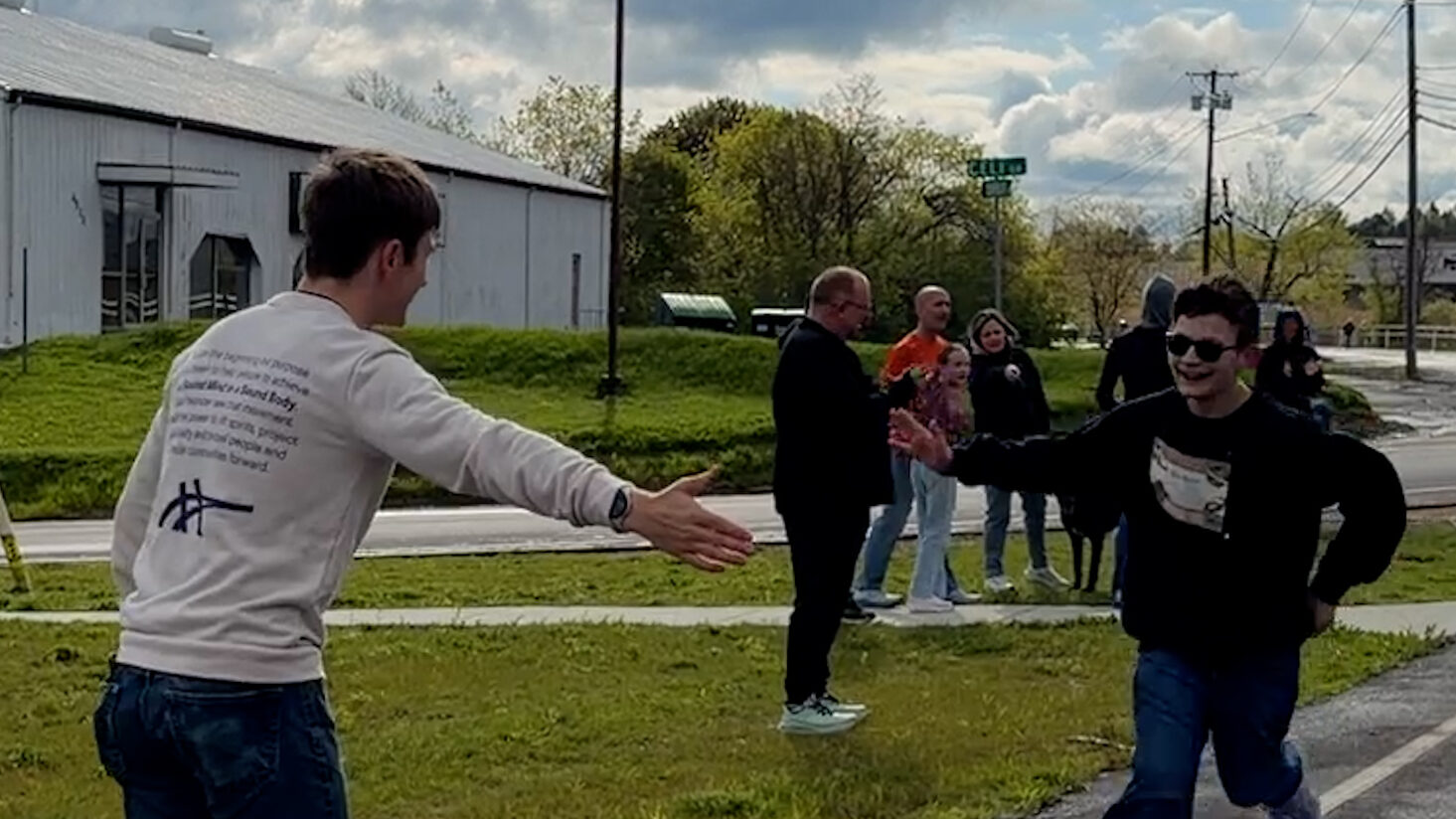 Kid runs to high-five man