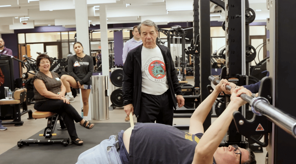 Ray using his knowledge of lifting to teach the youth proper techniques