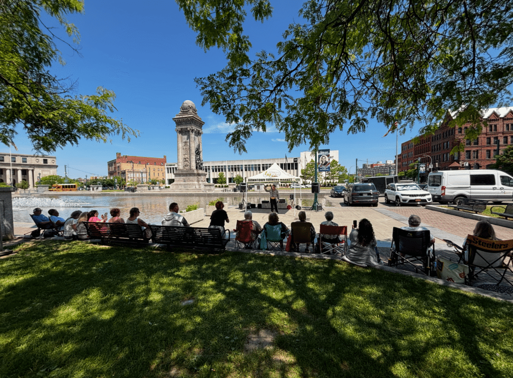 A crowd gathers for a live music performance in Clinton Square in Syracuse