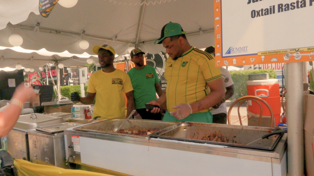 Chefs cook food in tent