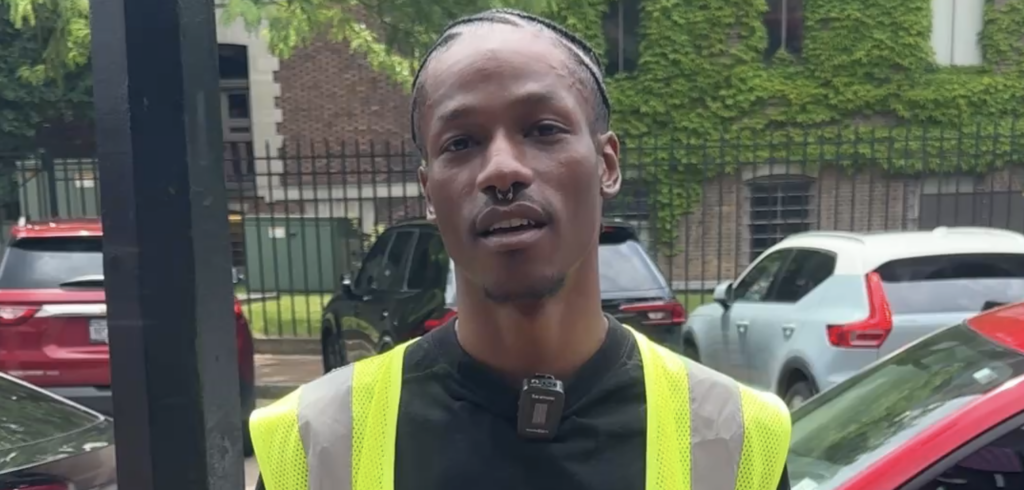 Man in black T-shirt and neon vest.
