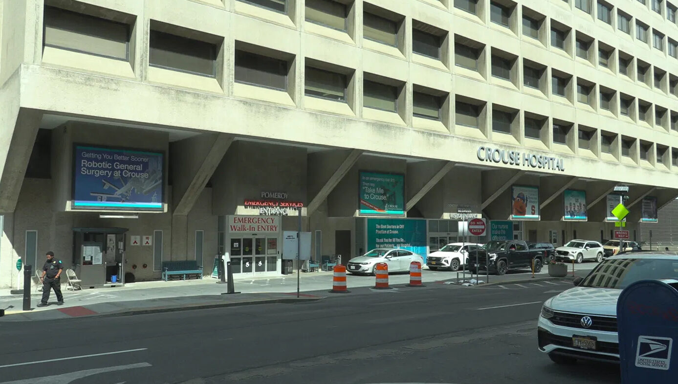 The exterior of Crouse Hospital in Syracuse, New York, showing the emergency walk-in entry and hospital signage.