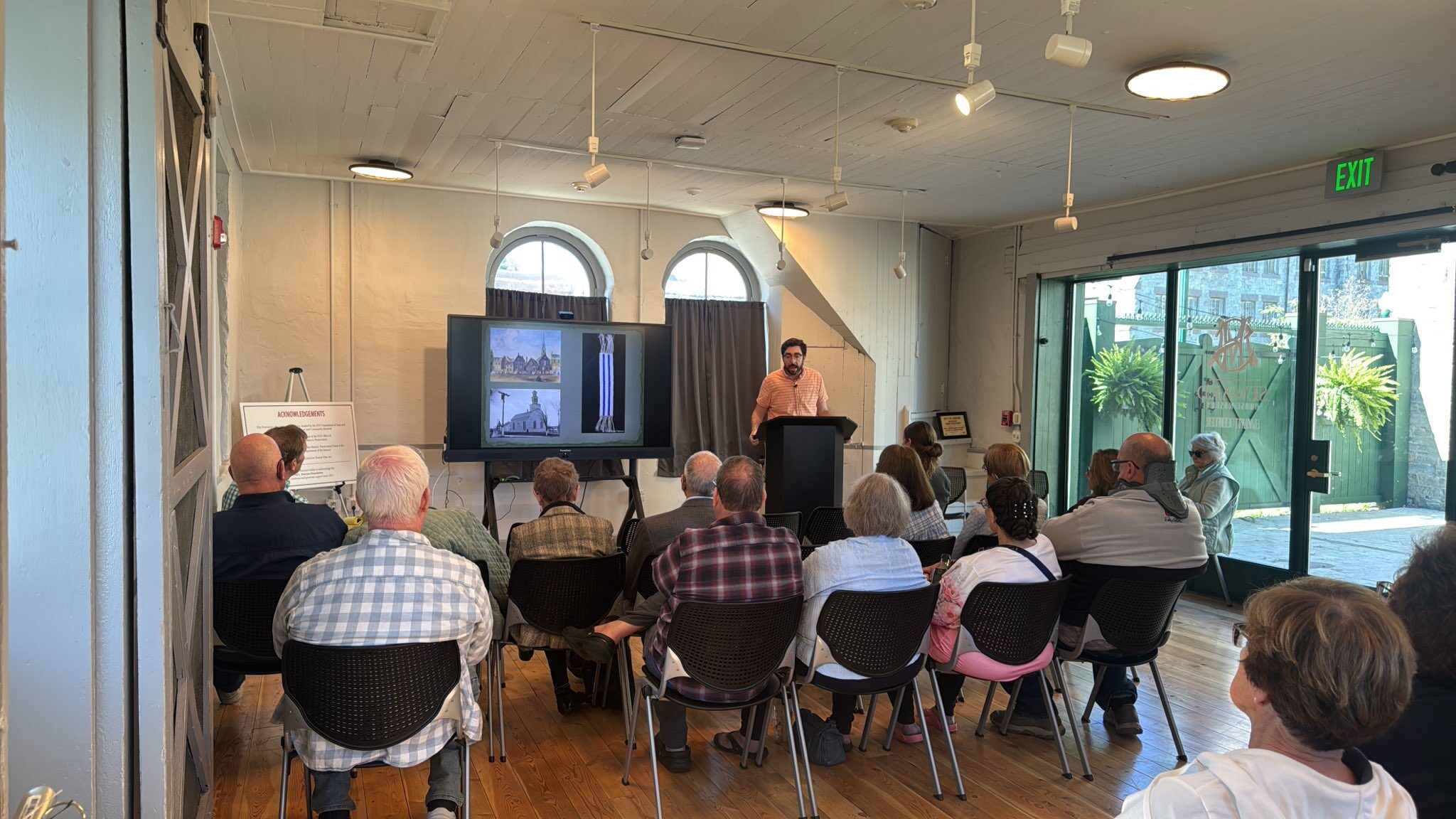 Man talking to a room full of people about the Erie Canal.
