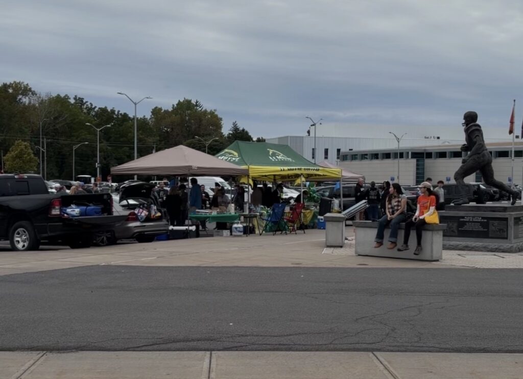 Le Moyne fans tailgate under a large Le Moyne tent.