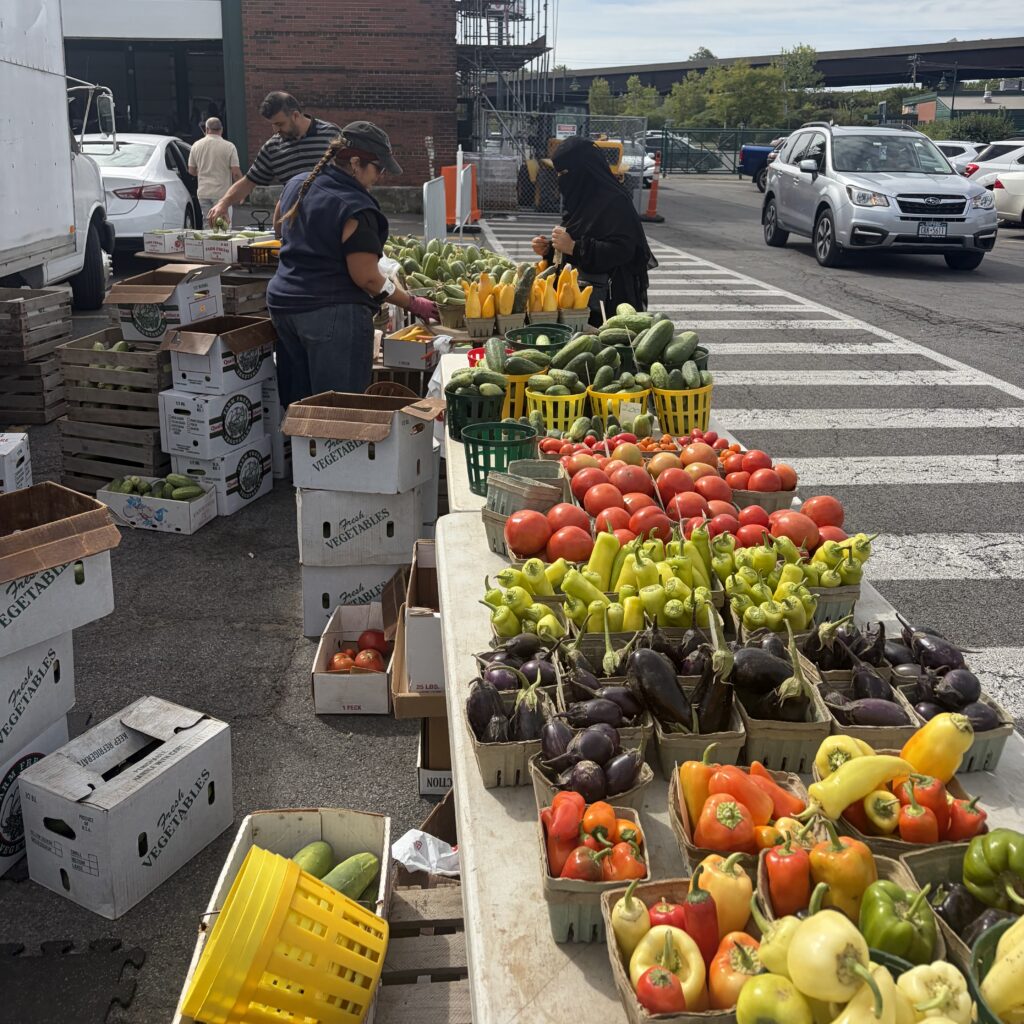 Melissa Turner helping customers at farmers market stand