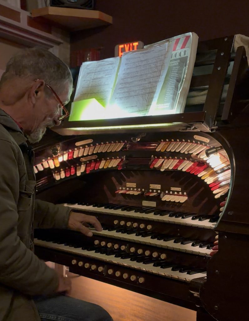 Organ technician playing an organ